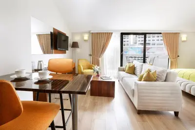 a living room with a white couch and a table at The White Orient Hotel in Istanbul