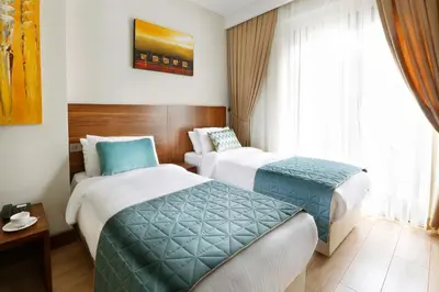 a hotel room with two beds and a window at The White Orient Hotel in Istanbul