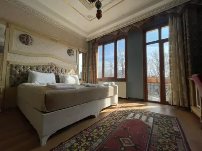 a bedroom with a bed and a large window at Optimist Hotel in Istanbul
