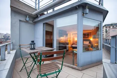 a balcony with a wooden table and a bench at Résidence Le Rêve in Istanbul