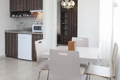 a kitchen with a white table and white chairs at Résidence Le Rêve in Istanbul