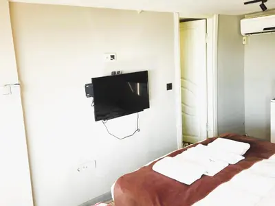 a hotel room with a bed and a flat screen tv at Résidence Le Rêve in Istanbul