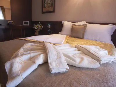 a bed with white blankets and pillows on it at Burckin Hotel in Istanbul