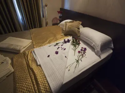a bed with flowers on top of it at Burckin Hotel in Istanbul