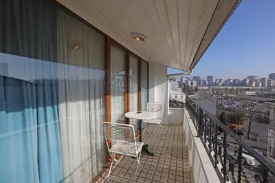 a balcony with a table and chairs on a building at Mezzo Hotel in Istanbul