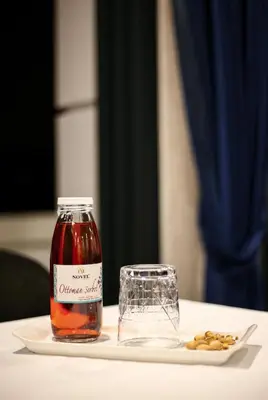 a bottle of orange sauce next to a plate of food at Novelty Hotel in Istanbul