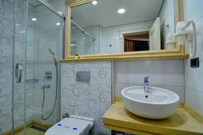 a bathroom with a sink and a shower and a toilet at Novelty Hotel in Istanbul