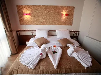 a bedroom with a bed with white sheets and towels at Arife Sultan Hotel in Istanbul