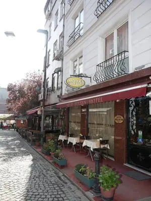 a building with tables and chairs on a street at Arife Sultan Hotel in Istanbul