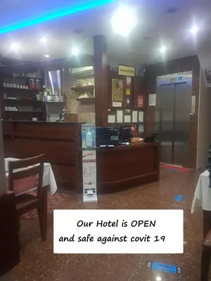 a hotel room with a ticket counter and a table at Arife Sultan Hotel in Istanbul