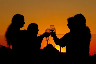 a group of people holding glasses of wine at sunset at Neorion Hotel - Special Class in Istanbul