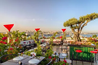 a restaurant with tables and chairs and a view of the city at Neorion Hotel - Special Class in Istanbul