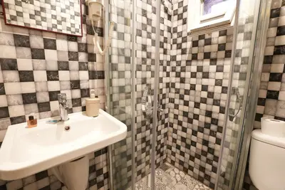 a bathroom with a sink and a shower at Cheers Vintage Hostel in Istanbul