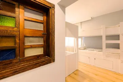 a room with a wooden door and a bunk bed at Cheers Vintage Hostel in Istanbul