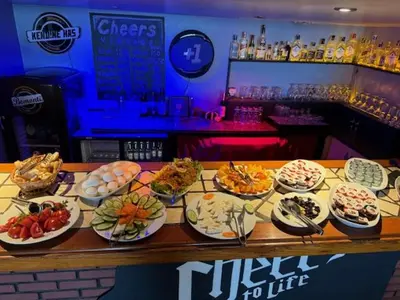 a bar with plates of food on a table at Cheers Vintage Hostel in Istanbul