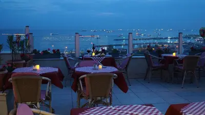 a restaurant with tables and chairs with a view of the ocean at Recital Hotel in Istanbul