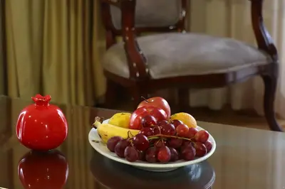 a plate of fruit on a table with a pomegranate at Recital Hotel in Istanbul