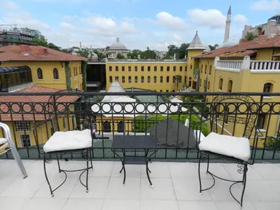a view of a balcony with chairs and buildings at Berk Guest House - Grandma's House in Istanbul