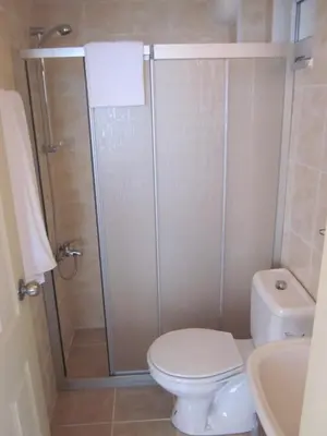a bathroom with a shower with a toilet and a sink at Istanbul Yildiz Hotel in Marmaraereglisi