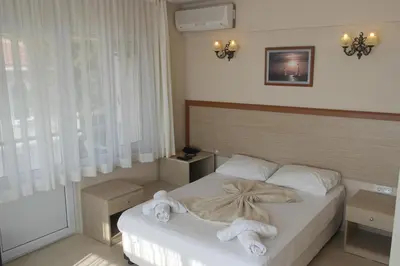 a bedroom with a bed with towels on it at Istanbul Yildiz Hotel in Marmaraereglisi