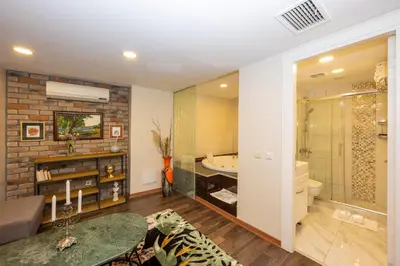 a living room with a bathroom with a bath tub at The Marions Suite istanbul Special Category Taksim in Istanbul