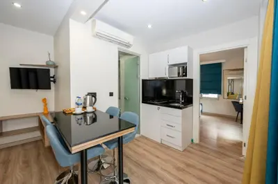 a kitchen with a table and chairs in a room at The Marions Suite istanbul Special Category Taksim in Istanbul