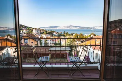 a balcony with two chairs and a table on a balcony at L'isola Guesthouse in Heybeliada