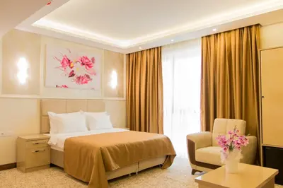 a hotel room with a bed and a chair at Goldhan Hotel in Tekirdag