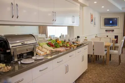 a kitchen with a buffet of food on a counter at Goldhan Hotel in Tekirdag