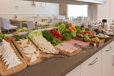 a buffet of vegetables and meats on a counter at Goldhan Hotel in Tekirdag