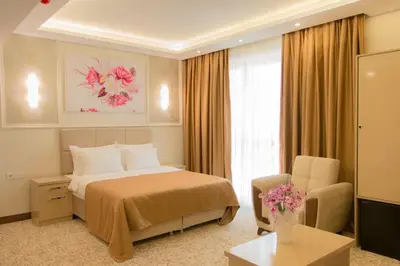 a hotel room with a bed and a chair at Goldhan Hotel in Tekirdag