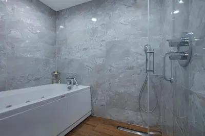 a bathroom with a shower and a sink and a tub at Hilton Garden Inn Yalova in Yalova