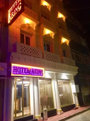 a building with a neon sign in front of it at ARINÇ HOTEL in Istanbul