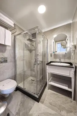 a bathroom with a shower and a toilet and a sink at Albinas Hotel Old City in Istanbul