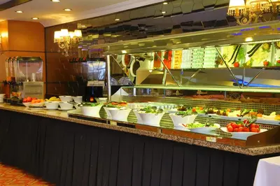 a buffet line with bowls of fruits and vegetables at Arya Hotel Sakarya in Sakarya