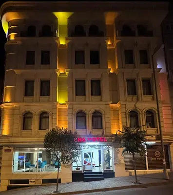 a building with a store in front of it at night at Ens Hotel in Istanbul
