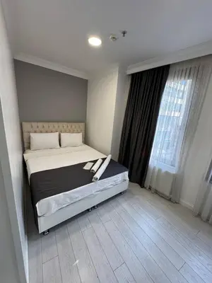 a bedroom with a bed and a large window at Ens Hotel in Istanbul