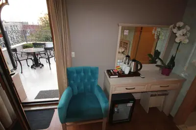 a room with a blue chair next to a mirror at Sultans Royal Hotel in Istanbul