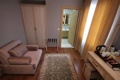a living room with a couch and a chair at Sultans Royal Hotel in Istanbul