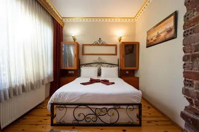 a bedroom with a bed with a bow on it at Gedikpasa Konagi Hotel in Istanbul