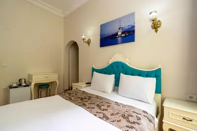 a bedroom with a bed with a blue headboard at Gedikpasa Konagi Hotel in Istanbul