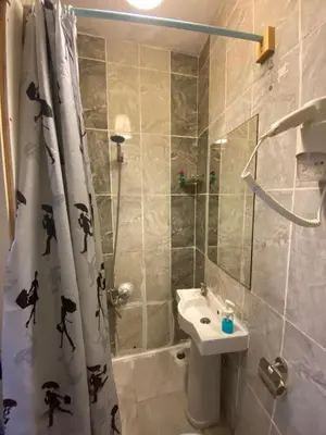 a bathroom with a shower curtain and a sink at Chez Bore in Istanbul