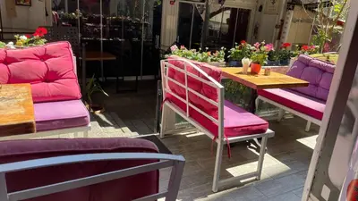 a table with pink chairs and a table with flowers at Chez Bore in Istanbul