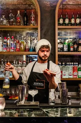 a man standing behind a counter in a bar at Cheers Porthouse in Istanbul