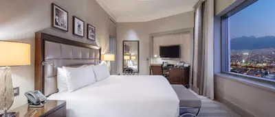a bedroom with a large white bed and a window at Hilton Bursa Convention Center & Spa in Bursa