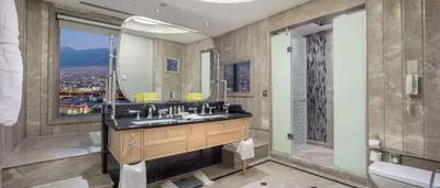 a bathroom with a sink and a shower and a mirror at Hilton Bursa Convention Center & Spa in Bursa