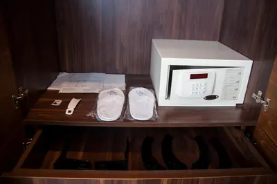 a microwave and pair of shoes on a wooden shelf at Old Port Hotel in Istanbul