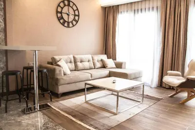 a living room with a couch and a clock on the wall at Old Port Hotel in Istanbul