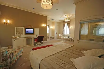 a bedroom with two beds and a television in it at Fuat Pasa Oteli - Special Category Bosphorus in Istanbul