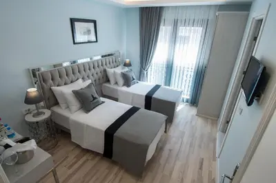 a hotel room with two beds and a television at Primero Hotel in Istanbul